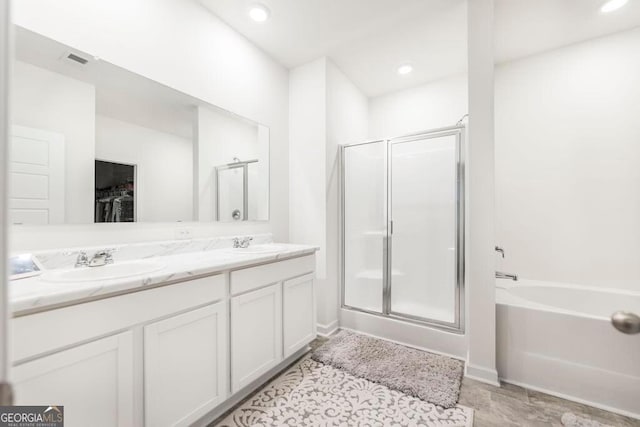 115 Taylor Woods Ct, Bonaire, GA 31005 - full bathroom featuring a shower stall, a garden tub, double vanity, and a spacious closet