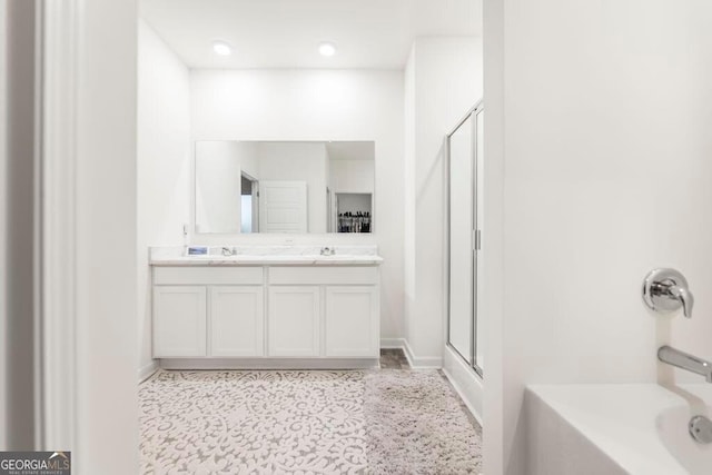 115 Taylor Woods Ct, Bonaire, GA 31005 - bathroom featuring an enclosed shower, double vanity, a bathtub, and baseboards
