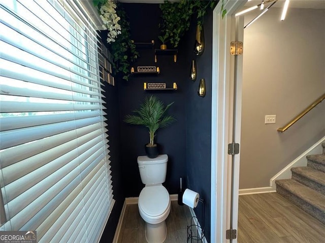 3615 Hawthorne Ter, Atlanta, GA 30337 - bathroom featuring toilet, wood finished floors, and baseboards