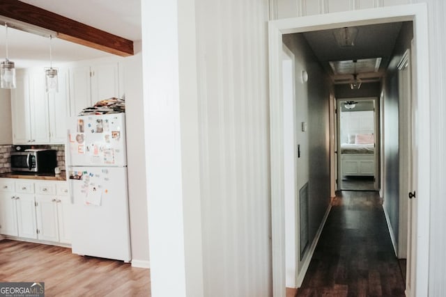 175 Briarwood Cir, Americus, GA 31709 - hall with wood finished floors, beamed ceiling, attic access, and baseboards