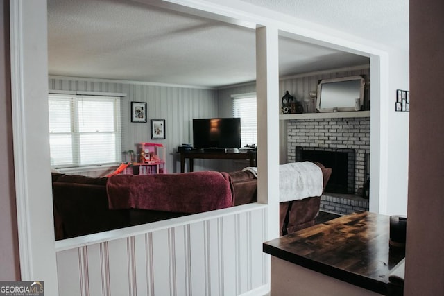 175 Briarwood Cir, Americus, GA 31709 - living area with crown molding, a fireplace, plenty of natural light, and a textured ceiling