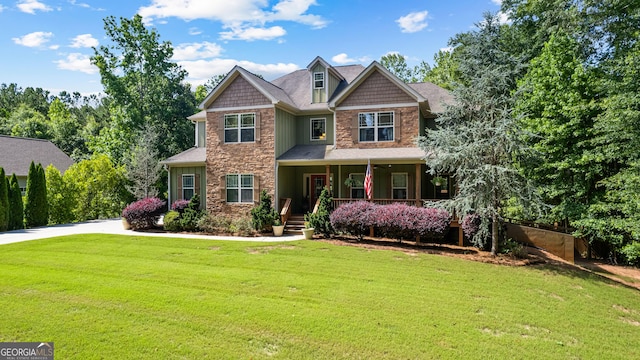 152 Magnolia Place Way, Senoia, GA 30276 - craftsman-style house featuring stone siding, covered porch, a front yard, and board and batten siding