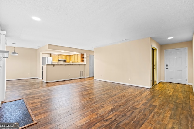 98 Hampshire Ct, Avondale Estates, GA 30002 - unfurnished living room featuring dark wood finished floors, recessed lighting, and a textured ceiling