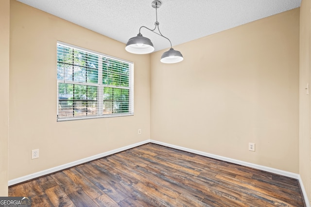98 Hampshire Ct, Avondale Estates, GA 30002 - empty room featuring dark wood-type flooring and a textured ceiling