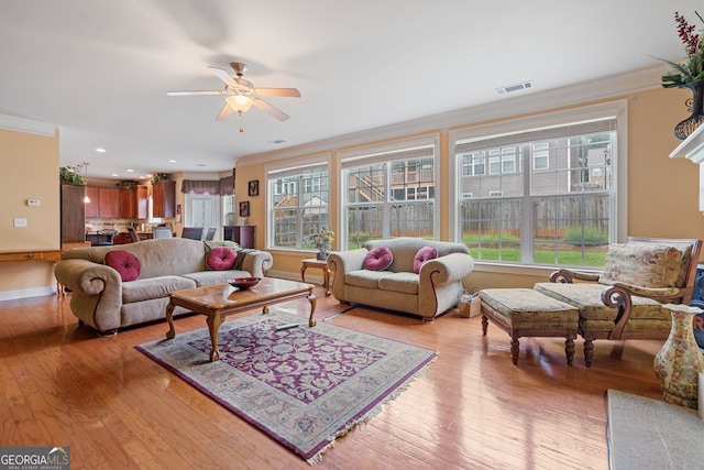 3476 Bridge Walk Dr, Lawrenceville, GA 30044 - living area featuring ornamental molding, light wood-style flooring, a ceiling fan, and baseboards