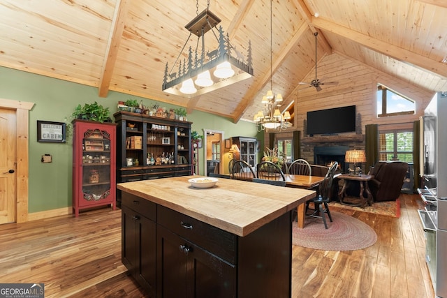 294 Turkey Trl, Jasper, GA 30143 - kitchen with wood counters, wood ceiling, open floor plan, light wood-style floors, and a stone fireplace
