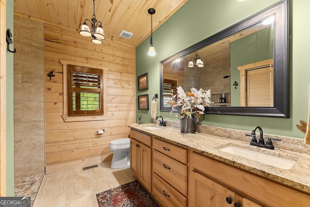 294 Turkey Trl, Jasper, GA 30143 - bathroom with a chandelier, wooden walls, double vanity, toilet, and a tile shower