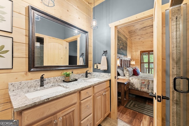 294 Turkey Trl, Jasper, GA 30143 - ensuite bathroom featuring double vanity, wooden walls, and wood finished floors