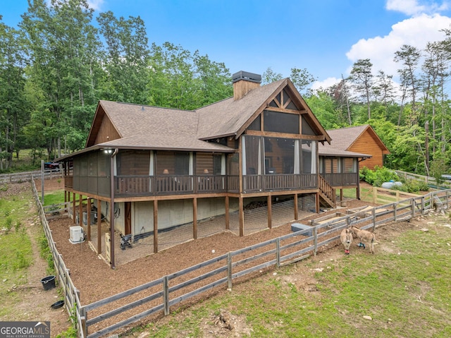 294 Turkey Trl, Jasper, GA 30143 - rear view of house featuring a sunroom, a shingled roof, a chimney, and a fenced backyard