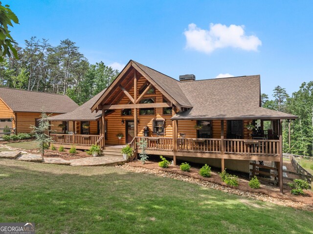 294 Turkey Trl, Jasper, GA 30143 - cabin featuring a shingled roof, a front lawn, log exterior, and a garage