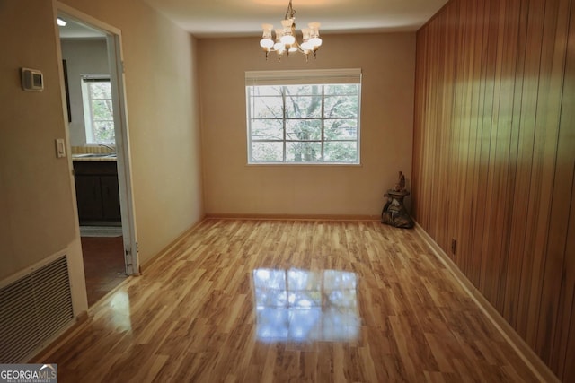 1381 NE Normandy Dr NE Unit 4, Atlanta, GA 30306 - unfurnished dining area featuring a chandelier, wood finished floors, a sink, and baseboards