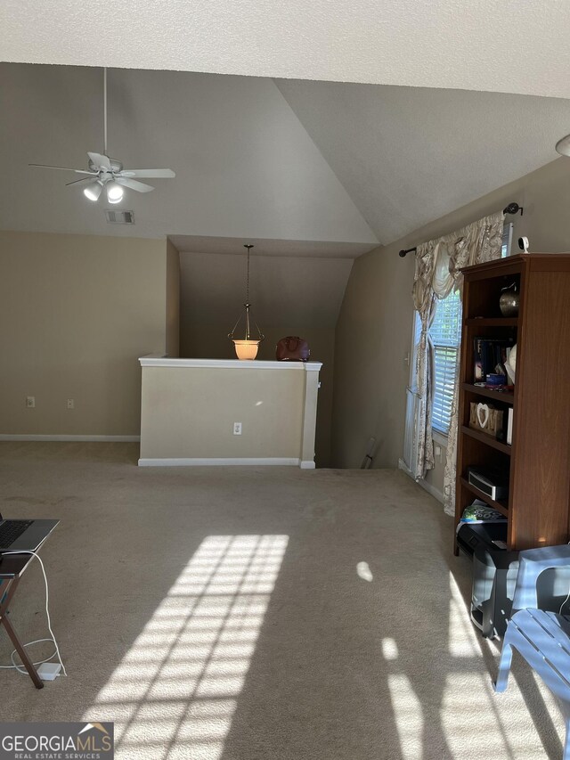 11657 Flemming Ct, Hampton, GA 30228 - unfurnished living room with lofted ceiling, carpet flooring, ceiling fan, and baseboards