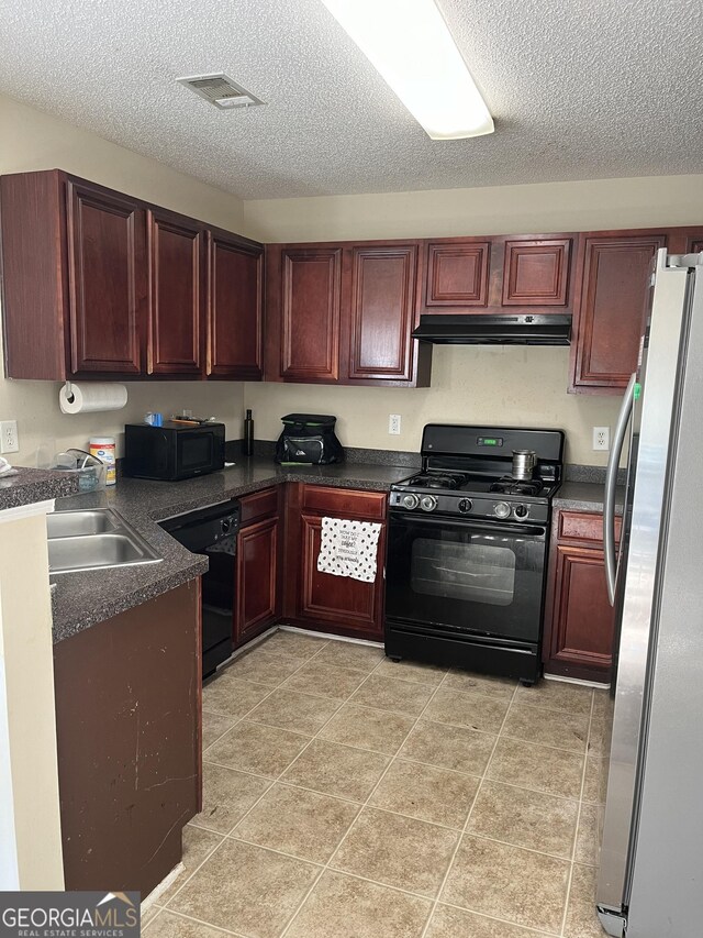 11657 Flemming Ct, Hampton, GA 30228 - kitchen with black appliances, under cabinet range hood, dark countertops, a textured ceiling, and a sink
