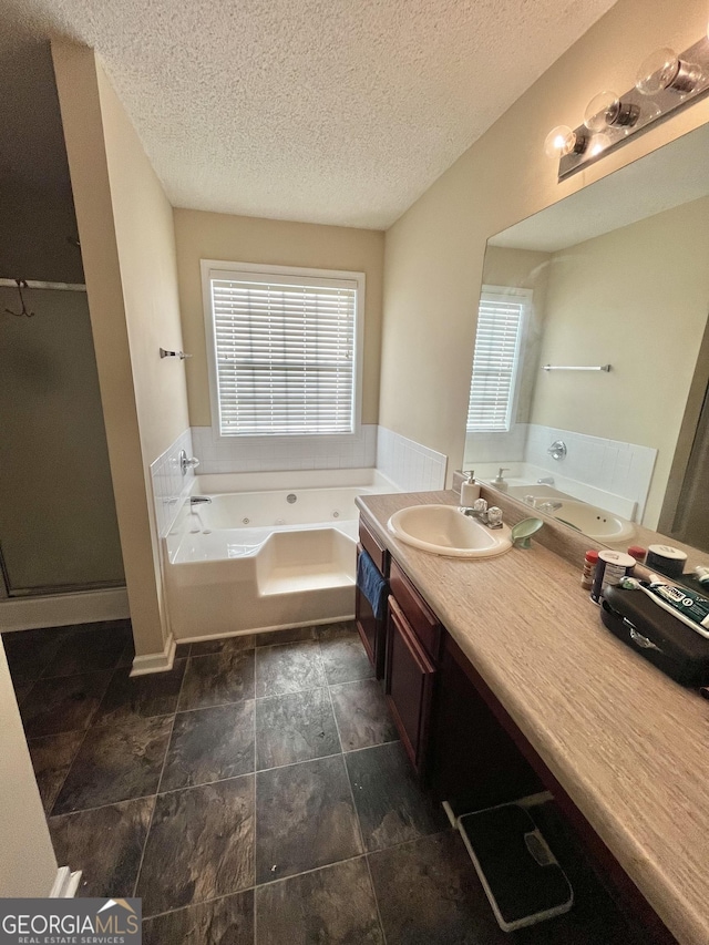 11657 Flemming Ct, Hampton, GA 30228 - full bathroom with plenty of natural light, a jetted tub, a textured ceiling, vanity, and a shower stall