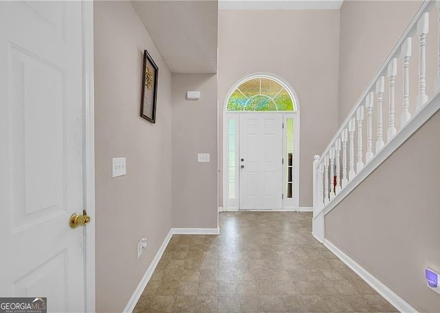 11657 Flemming Ct, Hampton, GA 30228 - foyer featuring baseboards, stone finish floors, and stairs