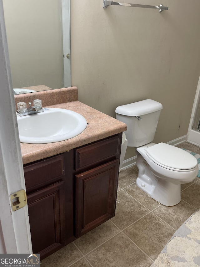 11657 Flemming Ct, Hampton, GA 30228 - bathroom featuring vanity, toilet, tile patterned flooring, and baseboards
