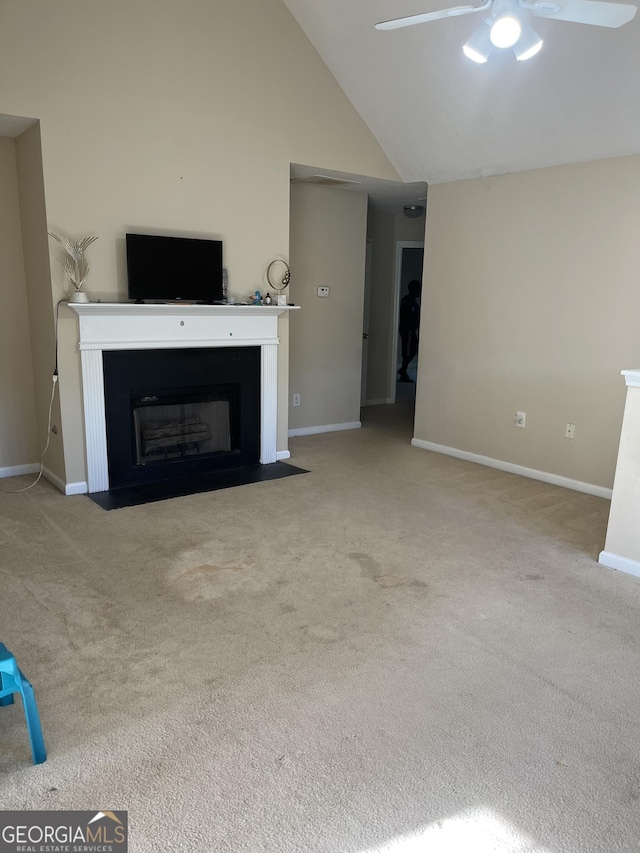 11657 Flemming Ct, Hampton, GA 30228 - unfurnished living room with ceiling fan, carpet flooring, a fireplace with flush hearth, baseboards, and high vaulted ceiling