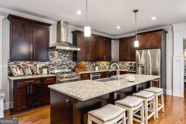 2603 Apple Valley Rd NE, Atlanta, GA 30319 - kitchen featuring wall chimney exhaust hood, stainless steel appliances, wood finished floors, light stone countertops, and ornamental molding