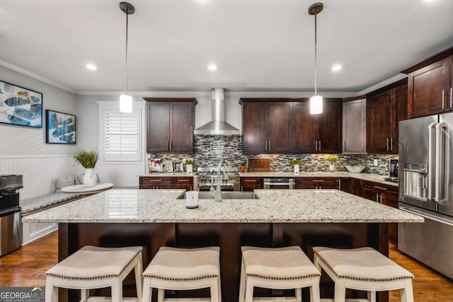 2603 Apple Valley Rd NE, Atlanta, GA 30319 - kitchen with high end fridge, wall chimney range hood, dark brown cabinetry, light stone countertops, and ornamental molding