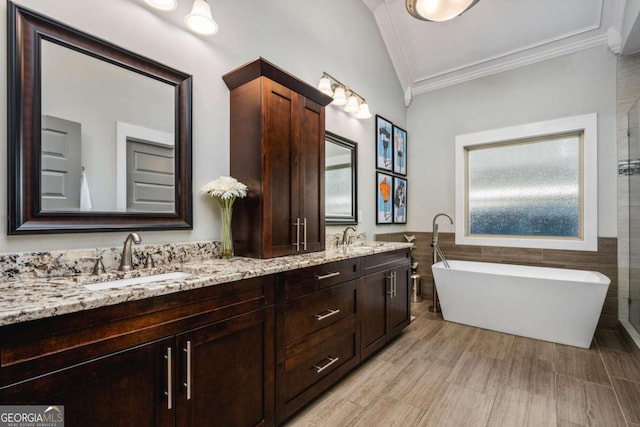 2603 Apple Valley Rd NE, Atlanta, GA 30319 - bathroom with crown molding, a freestanding bath, tile walls, and double vanity