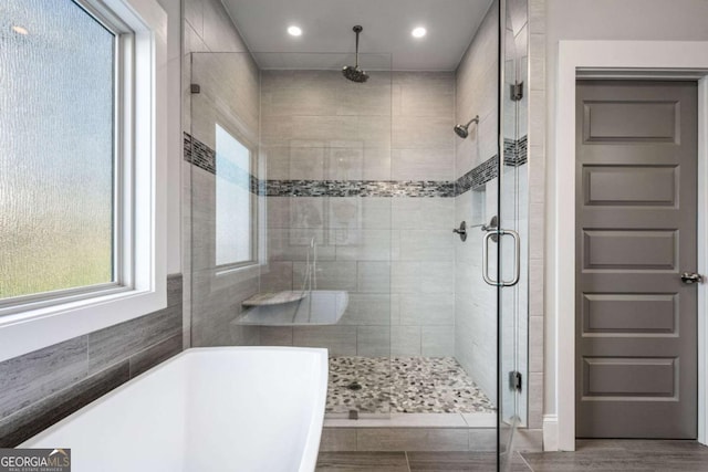 2603 Apple Valley Rd NE, Atlanta, GA 30319 - bathroom featuring healthy amount of natural light, a shower stall, recessed lighting, a freestanding bath, and wood finished floors