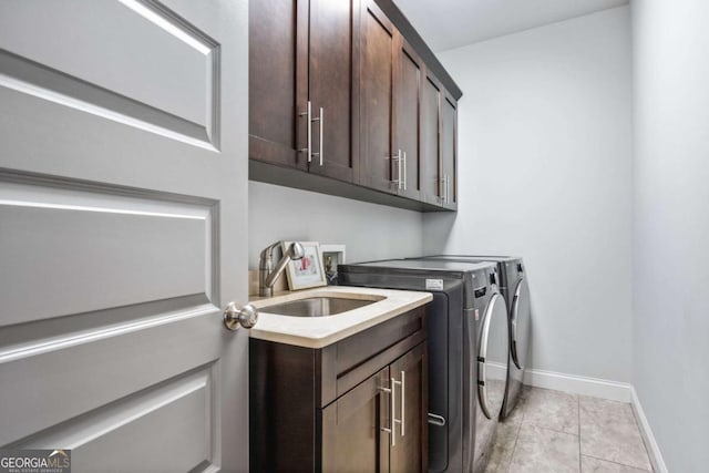2603 Apple Valley Rd NE, Atlanta, GA 30319 - laundry room with washing machine and dryer, cabinet space, and light tile patterned flooring