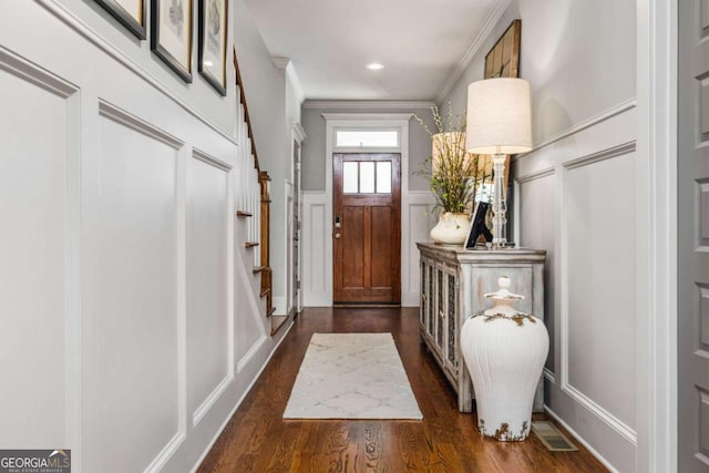 2603 Apple Valley Rd NE, Atlanta, GA 30319 - foyer entrance with a decorative wall, wainscoting, ornamental molding, and dark wood-type flooring