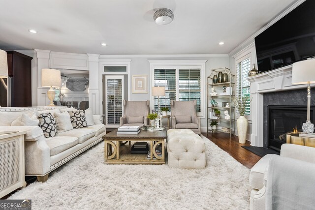 2603 Apple Valley Rd NE, Atlanta, GA 30319 - living area featuring crown molding, wood finished floors, a high end fireplace, recessed lighting, and beverage cooler
