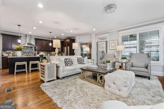 2603 Apple Valley Rd NE, Atlanta, GA 30319 - living area featuring wood finished floors, recessed lighting, and ornamental molding