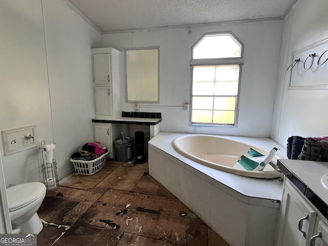542 Southern Pines Rd, Dublin, GA 31021 - bathroom featuring a garden tub, a textured ceiling, toilet, crown molding, and vanity