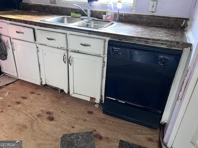 542 Southern Pines Rd, Dublin, GA 31021 - kitchen with dark countertops, a sink, and white cabinets