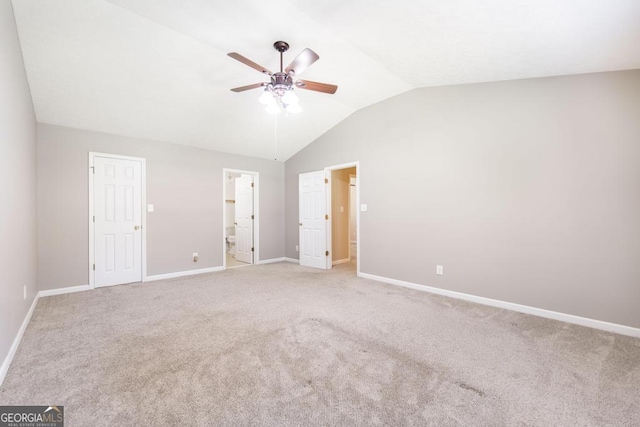 4407 Jones Rd, Macon, GA 31216 - unfurnished bedroom with vaulted ceiling, baseboards, light carpet, connected bathroom, and ceiling fan