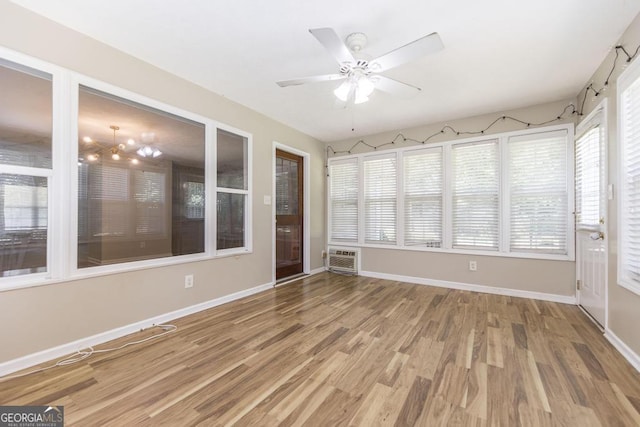 4407 Jones Rd, Macon, GA 31216 - unfurnished sunroom with wood finished floors, plenty of natural light, and baseboards