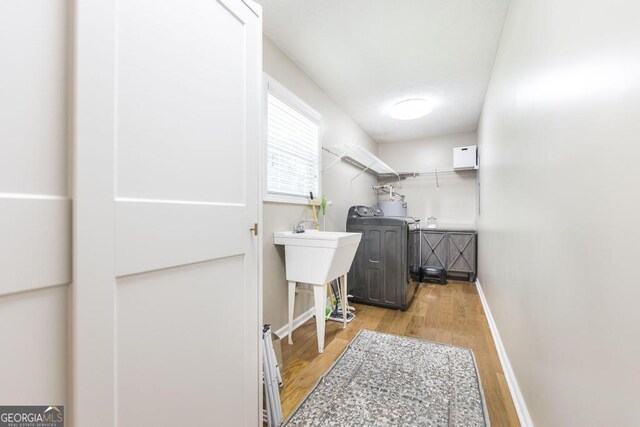 4407 Jones Rd, Macon, GA 31216 - laundry area with washer / clothes dryer, light wood finished floors, and baseboards