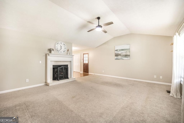 4407 Jones Rd, Macon, GA 31216 - unfurnished living room featuring a ceiling fan, vaulted ceiling, a fireplace with raised hearth, carpet flooring, and baseboards