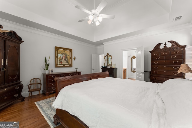5176 Glen Forrest Dr, Flowery Branch, GA 30542 - bedroom with a tray ceiling, wood finished floors, ceiling fan, ensuite bathroom, and ornamental molding