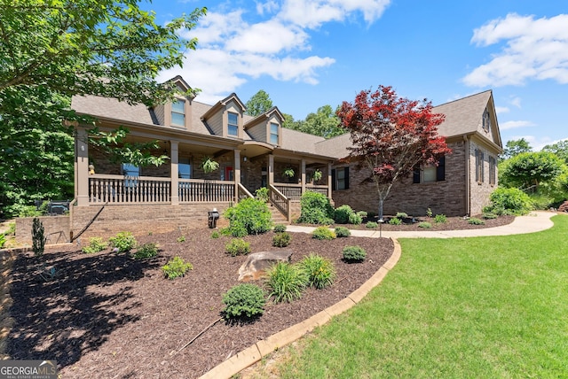 5176 Glen Forrest Dr, Flowery Branch, GA 30542 - new england style home with covered porch, a front yard, brick siding, and a shingled roof