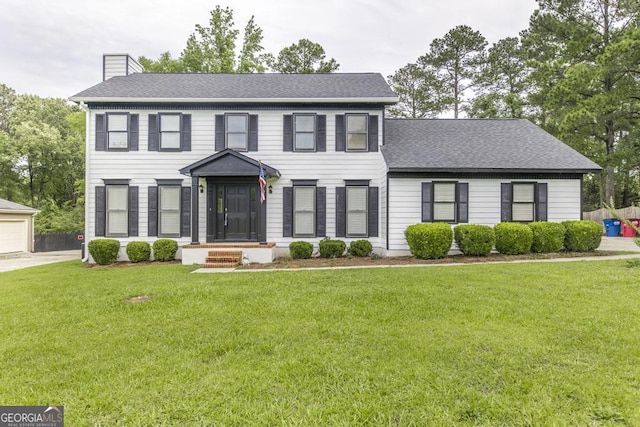 757 Silver Springs Dr, Macon, GA 31210 - colonial inspired home featuring a chimney, a front lawn, roof with shingles, and an outbuilding