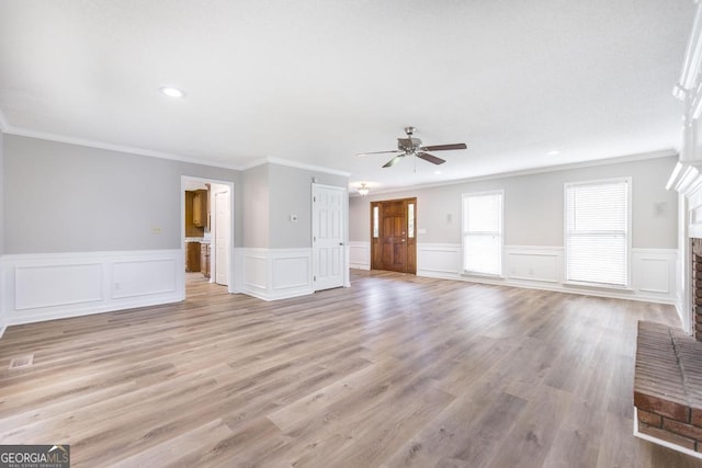757 Silver Springs Dr, Macon, GA 31210 - unfurnished living room featuring ceiling fan, ornamental molding, a brick fireplace, recessed lighting, and wainscoting