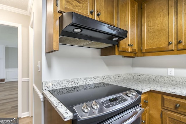 757 Silver Springs Dr, Macon, GA 31210 - kitchen featuring exhaust hood, stainless steel electric range, ornamental molding, brown cabinets, and wood finished floors