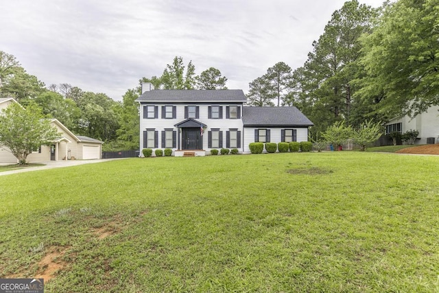 757 Silver Springs Dr, Macon, GA 31210 - colonial home featuring a chimney, a front lawn, a detached garage, and an outdoor structure