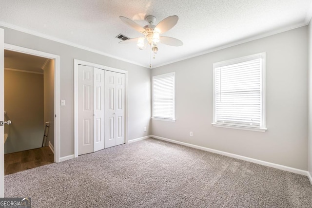 757 Silver Springs Dr, Macon, GA 31210 - unfurnished bedroom with carpet flooring, ornamental molding, a closet, ceiling fan, and a textured ceiling