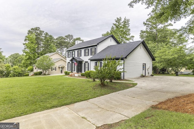 757 Silver Springs Dr, Macon, GA 31210 - colonial house featuring driveway, a front lawn, a shingled roof, and a chimney