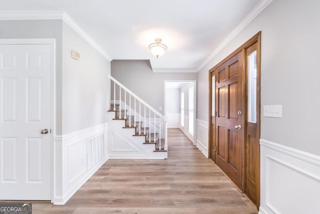 757 Silver Springs Dr, Macon, GA 31210 - foyer with stairway, a decorative wall, ornamental molding, a wainscoted wall, and light wood-style flooring