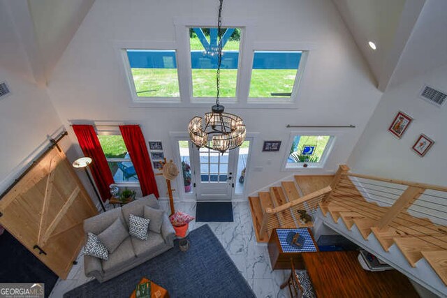 132 Fairview Meadows Dr, Demorest, GA 30535 - entryway with a chandelier, high vaulted ceiling, and marble look tile flooring