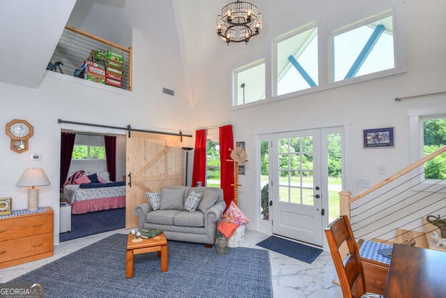 132 Fairview Meadows Dr, Demorest, GA 30535 - living area featuring marble look tile flooring, a high ceiling, a barn door, and a chandelier