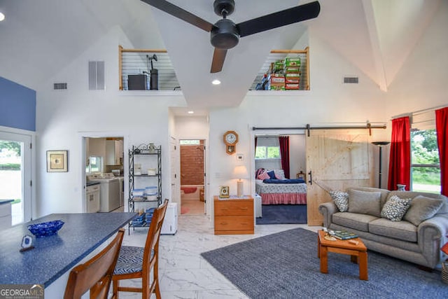 132 Fairview Meadows Dr, Demorest, GA 30535 - living area with high vaulted ceiling, marble finish flooring, a ceiling fan, and washer and clothes dryer