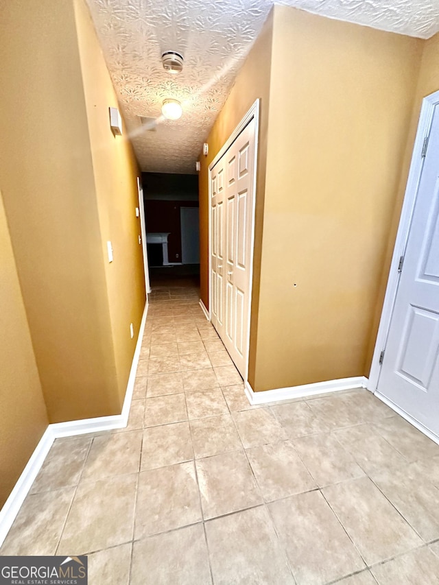 3793 SW Mays Ct SW, Atlanta, GA 30331 - hallway with light tile patterned floors, a textured ceiling, and baseboards