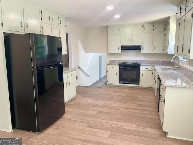 1028 Gate Post Ln, Lawrenceville, GA 30044 - kitchen featuring black appliances, a sink, under cabinet range hood, recessed lighting, and light stone countertops