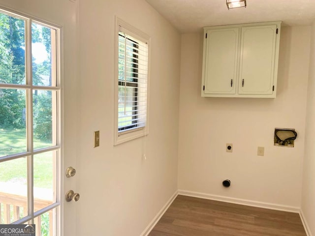 1028 Gate Post Ln, Lawrenceville, GA 30044 - laundry area featuring cabinet space, hookup for an electric dryer, baseboards, wood finished floors, and healthy amount of natural light